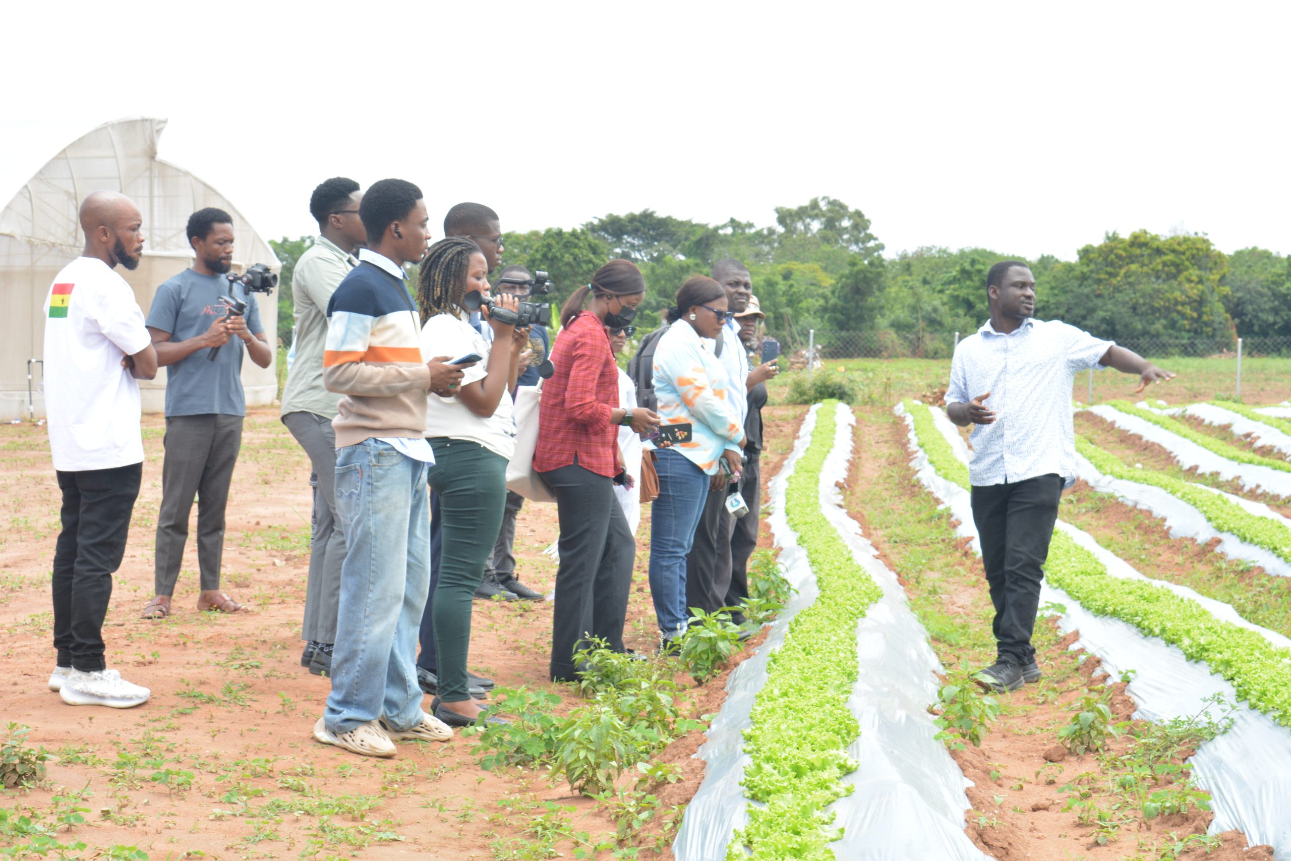 Samuel Agyemang, Co-Founder of Defarmercist Group, takes guests on a tour of the vegetable center (1)